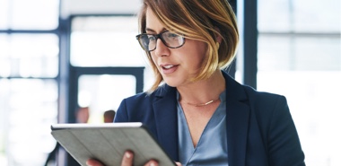 Photo of a woman watching a video on a tablet 