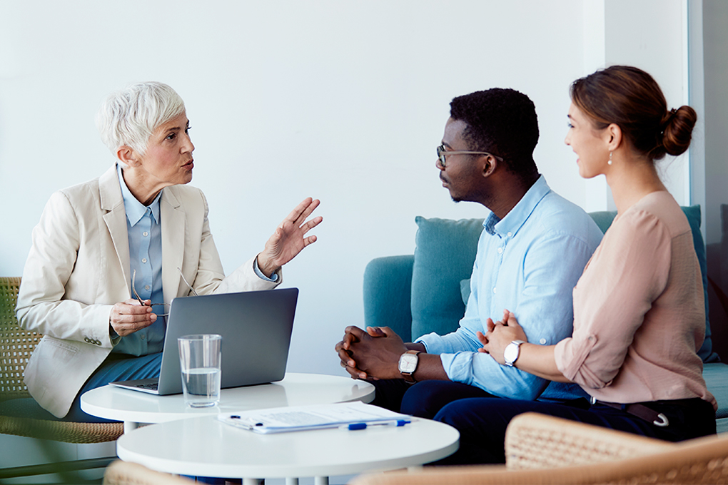 Photo of  an advisor and her clients