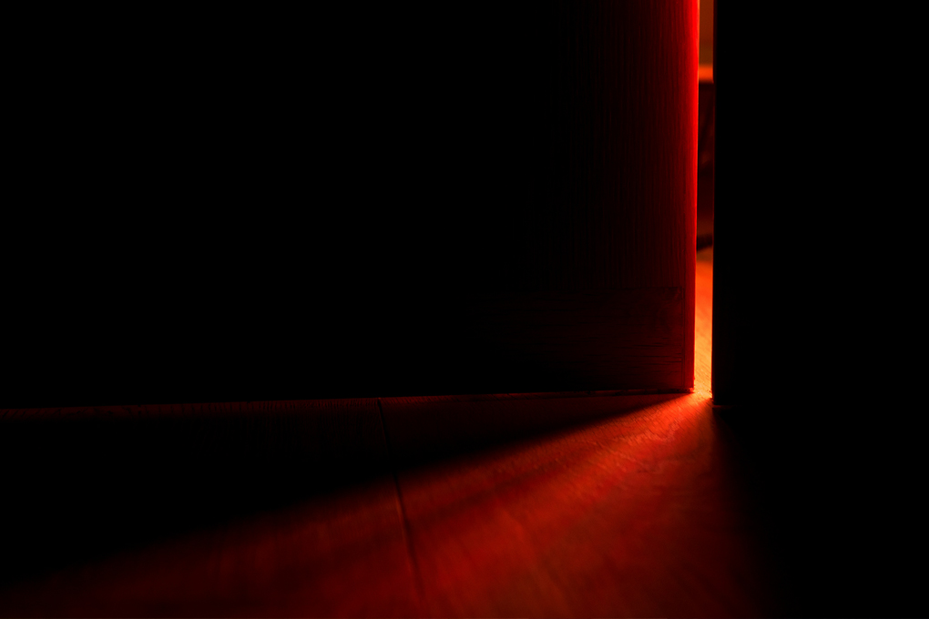 A door opening with a burst of red light.