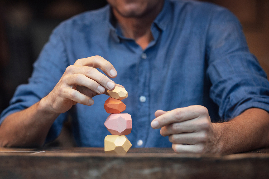 A person balancing small stones on top of each other