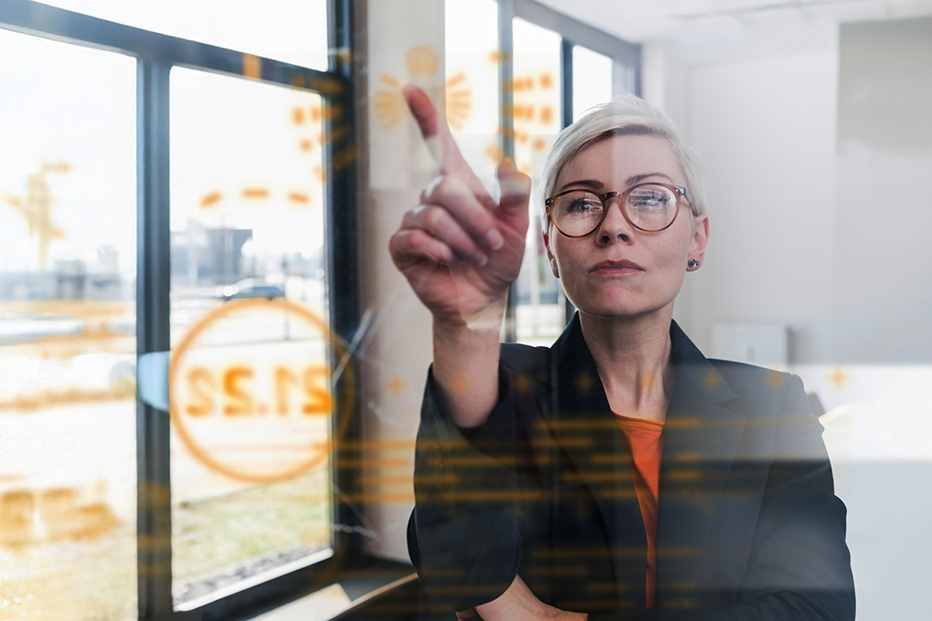 Image of a woman touching a screen